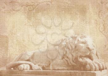 Sculpture of sleeping lion on grunge background with carved architectural details on stone as decoration on a facade building. Statue of lion in Lviv, Ukraine.