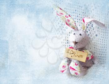 Cute hare. Happy Mother's Day bunnie holding board with the inscription I love mum. Greeting card for Mother's day.