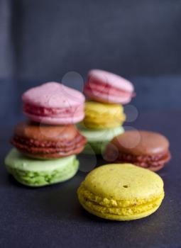 Colorful macaroons variety closeup on dark background. A french sweet delicacy. Dessert.