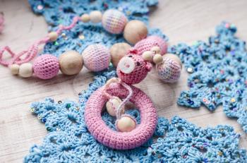 Necklace made from knitted pig and toys for the baby sitting in a sling. Sling necklace.