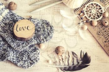 Composition with the inscription Love, wooden and knitted elements. Cozy photo in the style of a hugge.