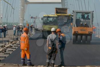 Taman, Russia - April 4, 2018: The construction of the Crimean bridge. Asphalt paving. Road works on the bridge.