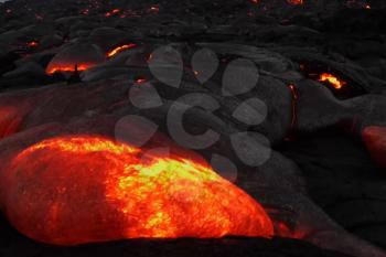 Pouring lava on the slope of the volcano. Volcanic eruption and magma