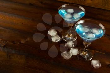 Blue cocktail with ice, copy space. Blue Martini. Blue Hawaiian cocktail. Blue curacao liqueur.  Blue margarita