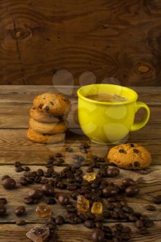 Coffee cup and chocolate cookie on wooden background. Cup of coffee