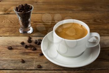 Coffee cup and coffee beans on rustic background. Cup of coffee. Strong coffee. Morning coffee. Coffee break. Coffee mug.  Coffee cup.