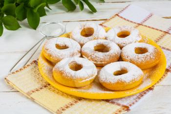 Delicious donuts on yellow plate. Sweet dessert. Sweet pastry. Doughnuts.  Donuts. Hanukkah donuts