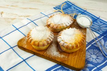 Small confiture pies and baking sieve. Jam pie. Small pie. Pie. Sweet pastry. Sweet dessert 