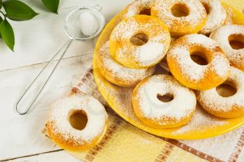 Sweet donuts on yellow plate. Sweet dessert. Sweet pastry. Donuts. Doughnuts.  