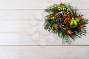 Christmas background with holiday golden cones decorated wreath. Christmas decoration with golden decor. Christmas greeting background. 