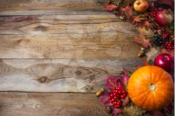 Thanksgiving  or fall greeting background with pumpkins and fall leaves. Thanksgiving background with seasonal vegetables and fruits. Fall background. Copy space