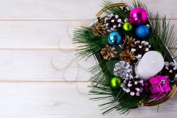 Christmas background with holiday ornaments, candle and pine cones centerpiece. Christmas decoration with pine cones. Christmas party background. Copy space.