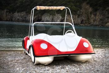 Quirky water boat with white, red paint. Parked in sandy, rocky seashore. It is settled in an island and used for the tourist for their travel in the pristine water of the islet. 