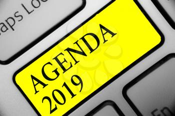 Conceptual hand writing showing Agenda 2019. Business photo showcasing list of activities in order which they are to be taken up Keyboard yellow key computer computing reflection document