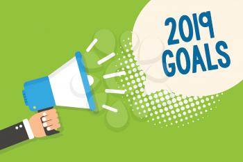 Text sign showing 2019 Goals. Conceptual photo A plan to do for something new and better for the coming year Man holding megaphone loudspeaker speech bubble green background halftone