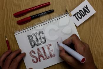Conceptual hand writing showing Big Sale. Business photo showcasing putting products on high discount Great price Black Friday Man holding marker notebook reminder wooden table cup coffee