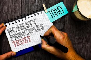Word writing text Honesty Principles Trust. Business concept for believing someone words for granted Telling truth Man holding marker notebook clothespin hold reminder coffee cup wood table