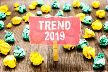 Word writing text Trend 2019. Business concept for things that is famous for short period of time in current year Clothespin holding pink note paper crumpled papers several tries mistakes