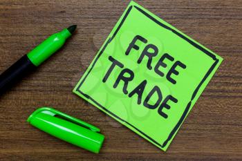 Conceptual hand writing showing Free Trade. Business photo showcasing The ability to buy and sell on your own terms and means Green Paper Communicate ideas Marker Wooden background