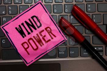 Writing note showing Wind Power. Business photo showcasing use of air flowto provide mechanical power to turn generators Pink paper keyboard Inspiration communicate ideas messages Red markers