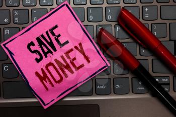 Writing note showing Save Money. Business photo showcasing store some of your cash every month to use them sometime later Pink paper keyboard Inspiration communicate ideas messages Red markers