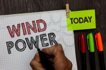 Conceptual hand writing showing Wind Power. Business photo text use of air flowto provide mechanical power to turn generators Man holding marker notebook clothespin markers wooden table