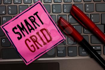 Writing note showing Smart Grid. Business photo showcasing includes of operational and energy measures including meters Pink paper keyboard Inspiration communicate ideas messages Red markers