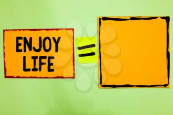 Writing note showing Enjoy Life. Business photo showcasing Any thing, place,food or person, that makes you relax and happy Orange paper notes reminders equal sign important messages to remember
