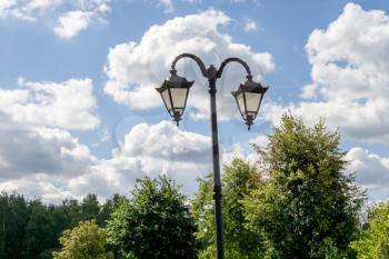 Vintage street lamp in the city park at sunny day.