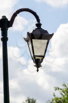 Vintage street lamp in the city park at sunny day.