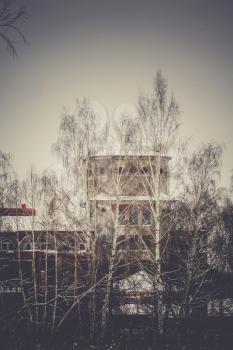 Vintage style red brick building, old factory, filtered winter time landscape.