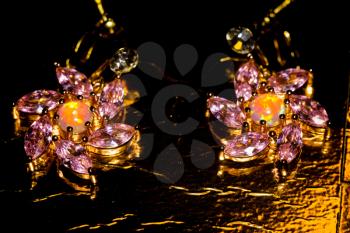 Fashion rose gold earrings with pink zircon and synthetic opal stone.
