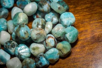Light blue natural larimar stone beads in an irregular shape.