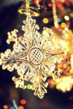 Abstract background with yellow sparkling snowflake made of plastic.
