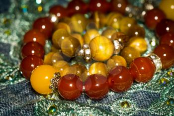 Boho beaded bracelets with red and brown stones.