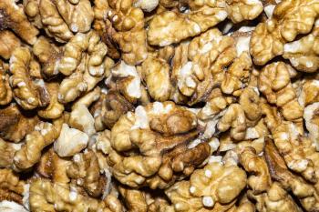 Close up background with peeled walnuts, macro photo. 