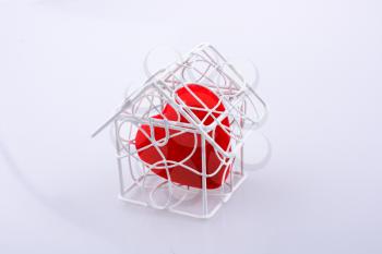 Red heart shape icon in metal wired house model