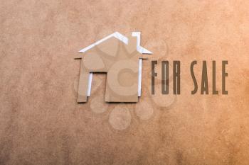 Little paper houses on a brown background