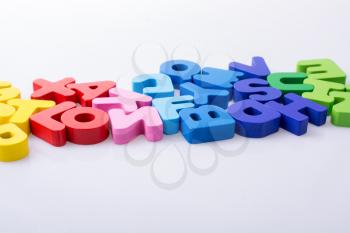 Colorful alphabet letter blocks scattered randomly on white background