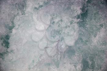 Water surface as a background with foam and bubbles