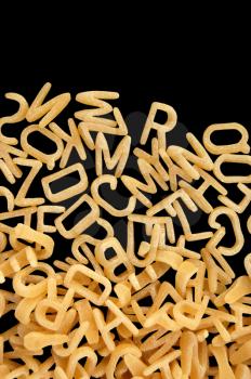 Alphabet soup pasta detail. Children's food background.
