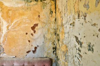 Peeling paint grunge wall in abandoned interior. Background texture.