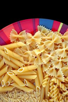 Colorful plate with italian pasta variety. Creative food background.