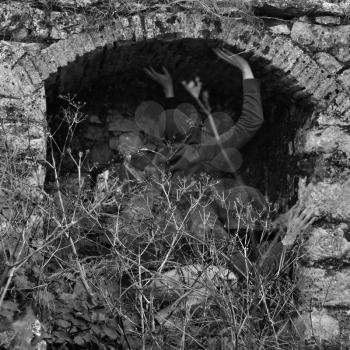 Obscured figures in arched abandoned structure. Double exposure black and white.
