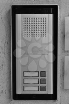 Doorphone intercom doorbell with buttons and speaker. Black and white.
