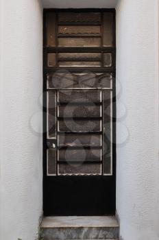 Old metal door frame with abstract classic pattern. Architectural detail.