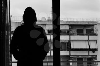 Man looking at city view through window abstract silhouette. Black and white.
