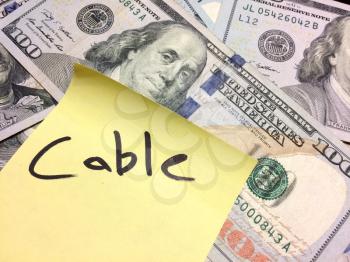 American cash money and yellow paper note with text Cable in black color aerial view