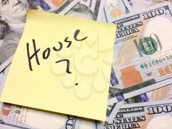 American cash money and yellow sticky note with text House with question mark in black color aerial view