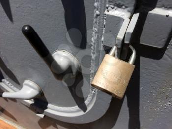 Padlock key on locked metal steel strong door concept on USS Iowa naval warship destroyer battleship